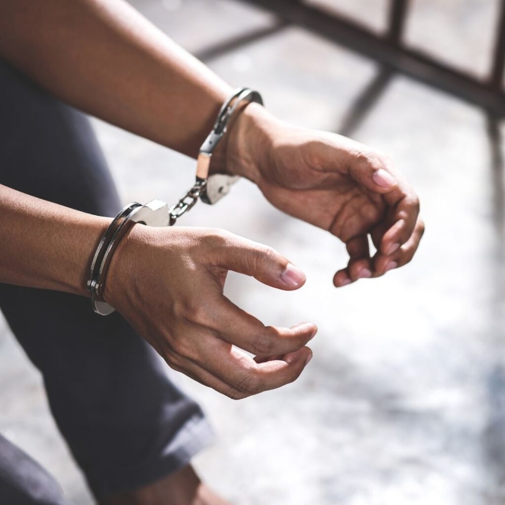 handcuffed hands held out