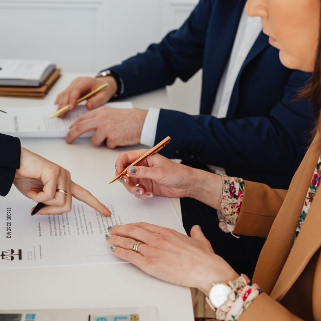 couple looking over paperwork with attorney