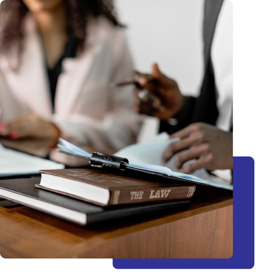 Houston Criminal Defense Lawyer image 4 attorneys talking with legal books in front of them