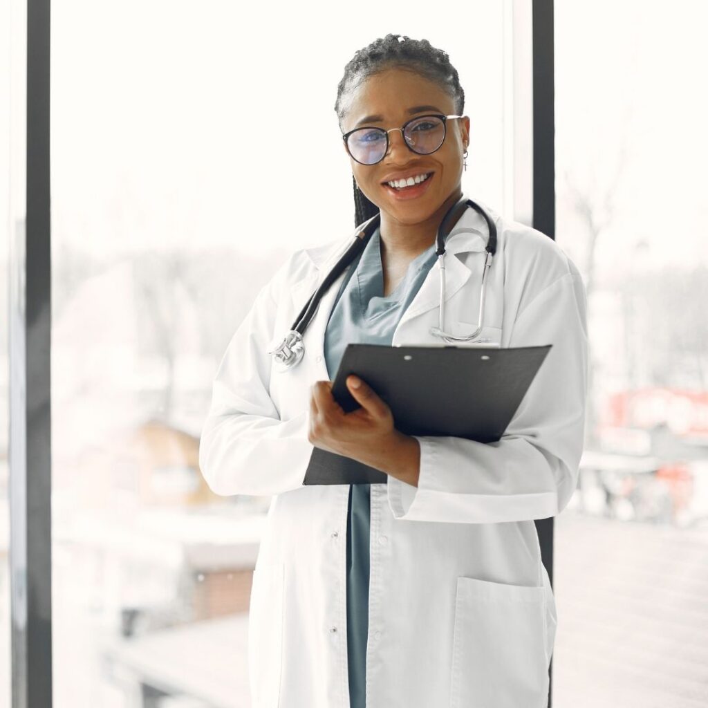 smiling doctor holding a tablet