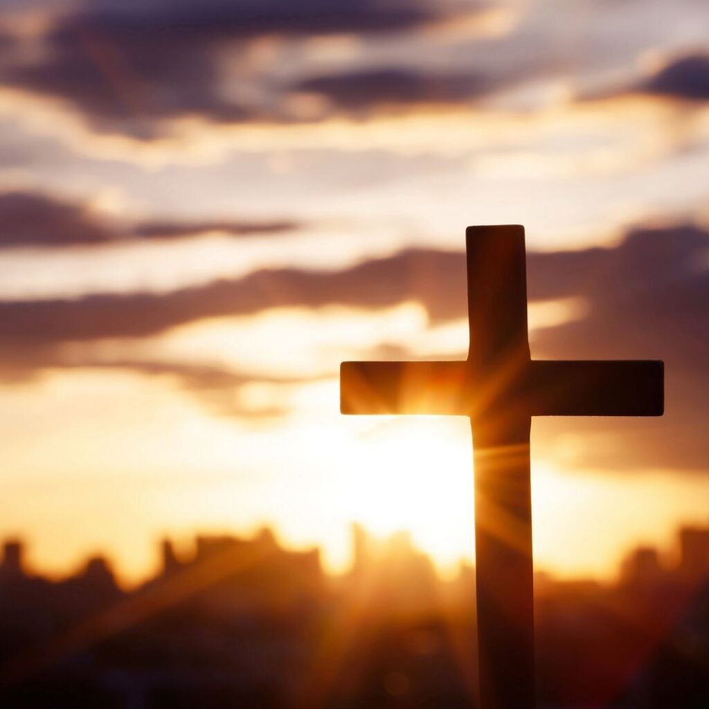 cross with a sunset peaking behind it