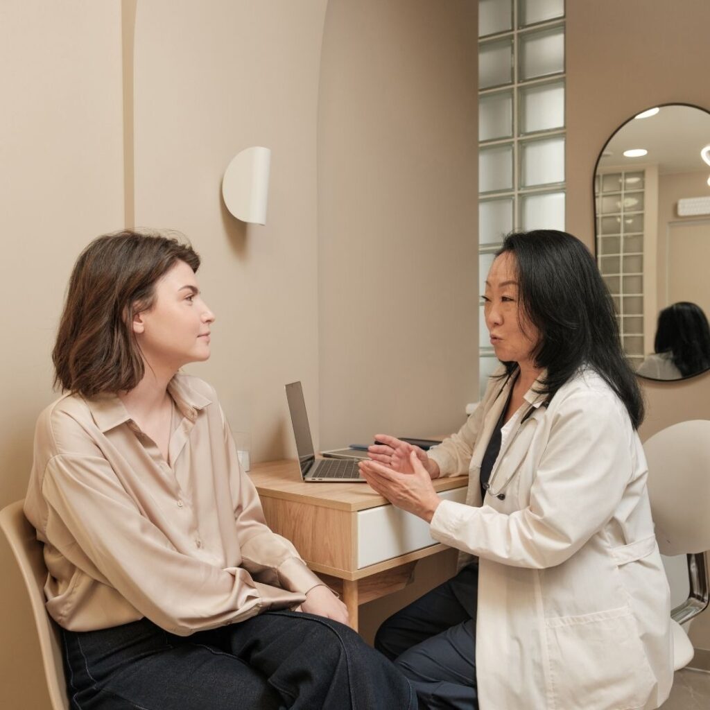 a woman talking to a doctor