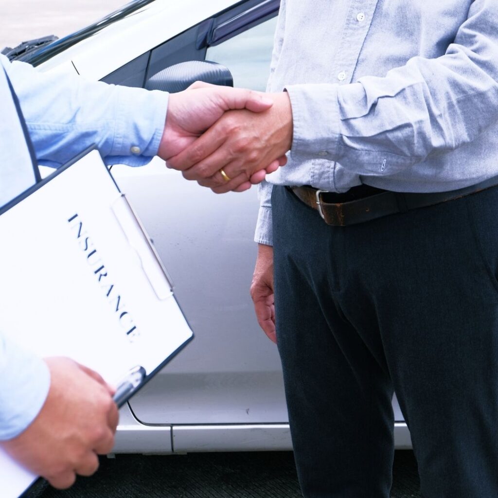 insurance adjuster shaking hands with client