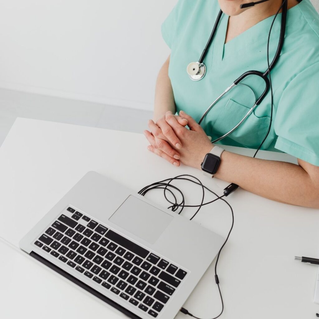 doctor filing out medical records online